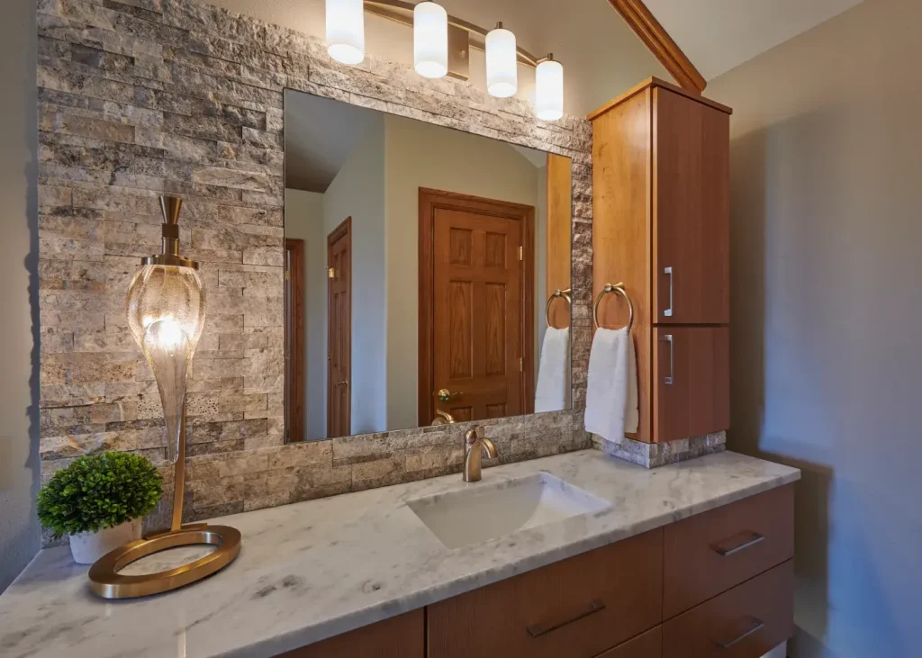 Contemporary bathroom design featuring built-in lighting, vessel sink, and sleek storage solutions