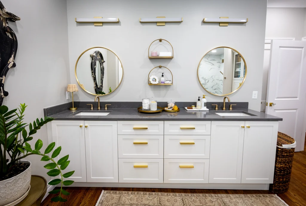 Modern bathroom remodel in Tulsa with white cabinetry and gold fixtures