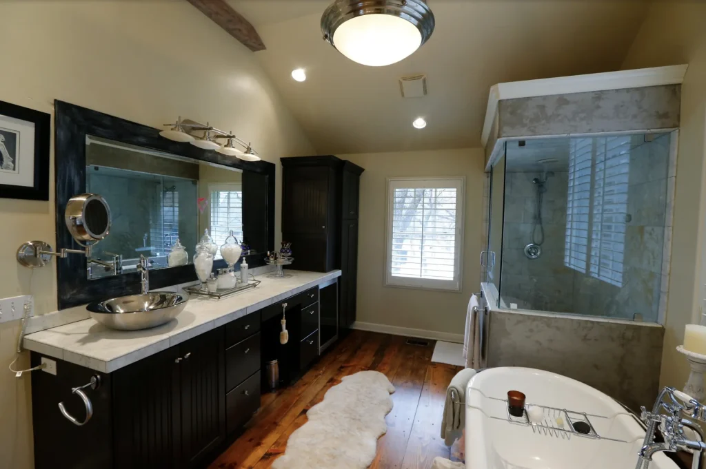 Traditional bathroom remodel with dark vanity and glass shower