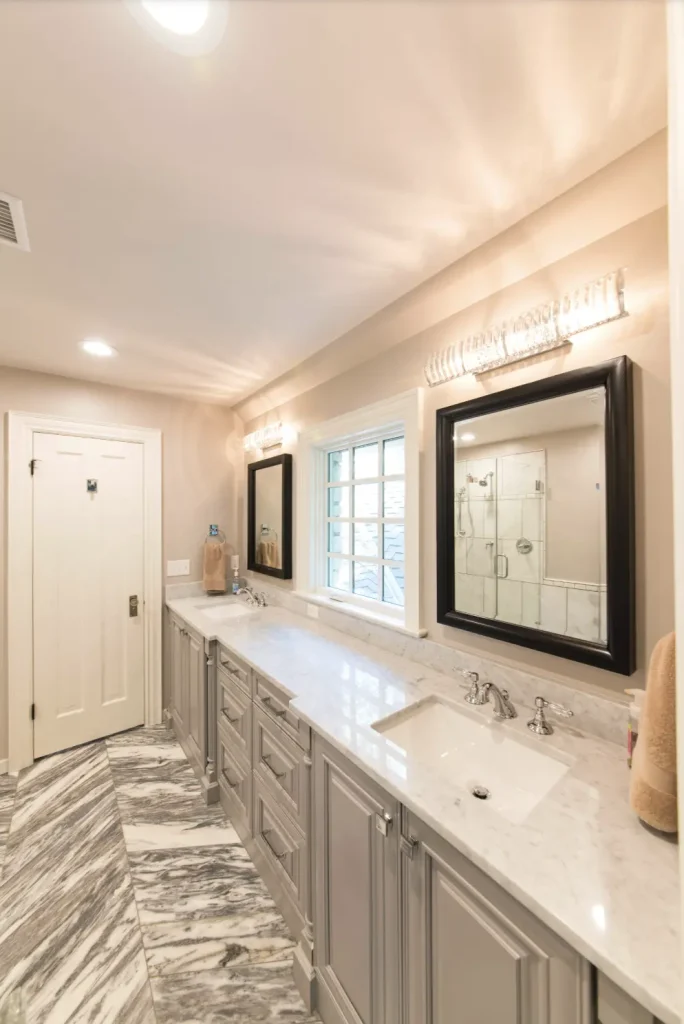Elegant bathroom remodel with double vanity and marble countertops